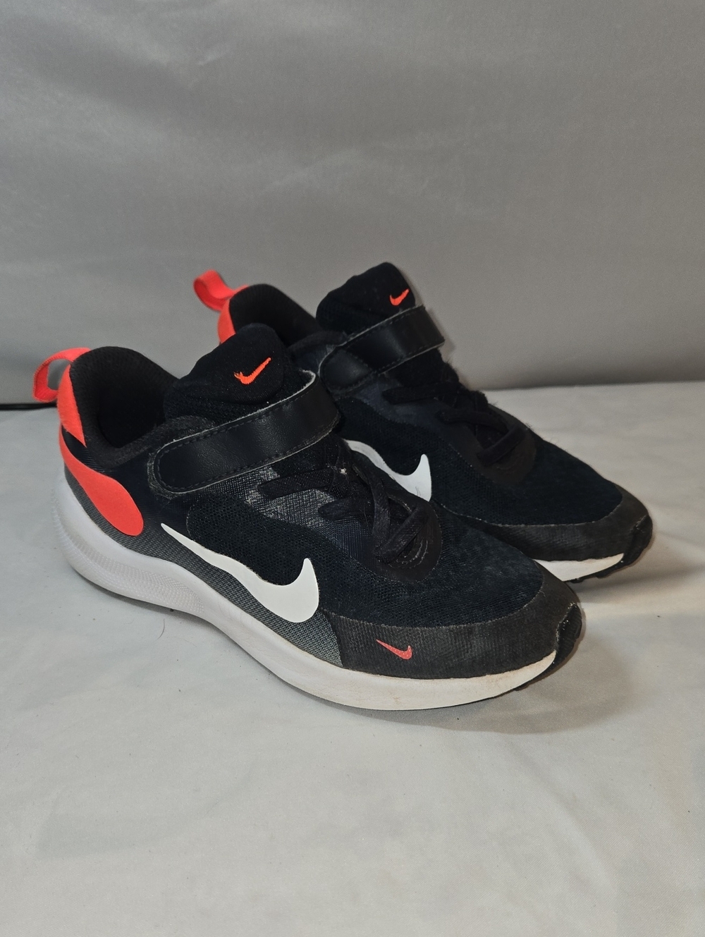 Nike Kids Black Sneakers with White Swoosh and Red Accents